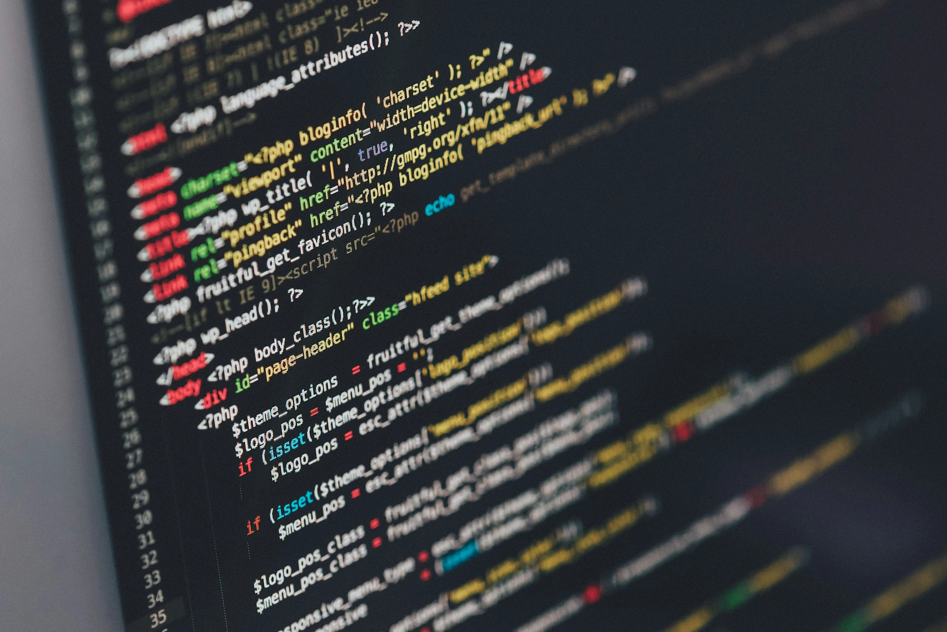 Close-up of a computer screen displaying PHP and HTML code from a WordPress blog template