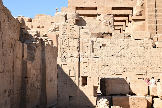 A captivating section of Karnak Temple, featuring walls densely adorned with hieroglyphic inscriptions. These ancient carvings narrate the religious and political achievements of pharaohs, preserving the legacy of Egypt's New Kingdom era.