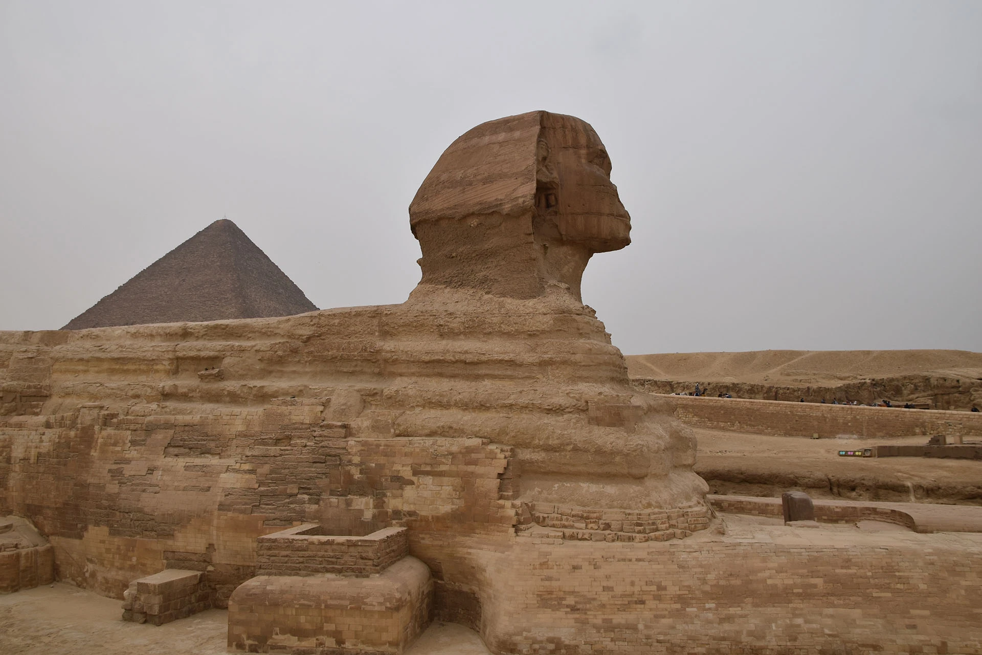 The Great Sphinx of Giza stands as a sentinel of history, its enigmatic gaze aligned with the timeless pyramid of Khafre in the background.