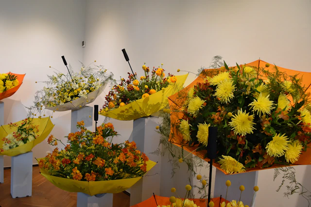 Inside Ksiaz Castle, a flower festival presents vibrant arrangements of chrysanthemums, ranunculus, and freesias, merging natural beauty with timeless elegance.