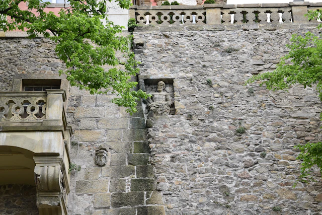 The external elevation of Ksiaz Castle highlights its robust stone architecture, adorned with embedded sculptures and decorative details. These features reflect the castle's rich historical legacy and artistic craftsmanship.