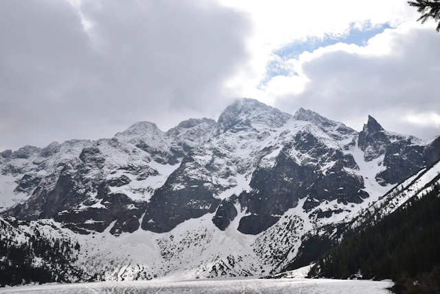 Snow-covered Mieguszowiecki Summits tower above Morskie Oko, creating a dramatic and iconic alpine view in the heart of the Tatra Mountains.