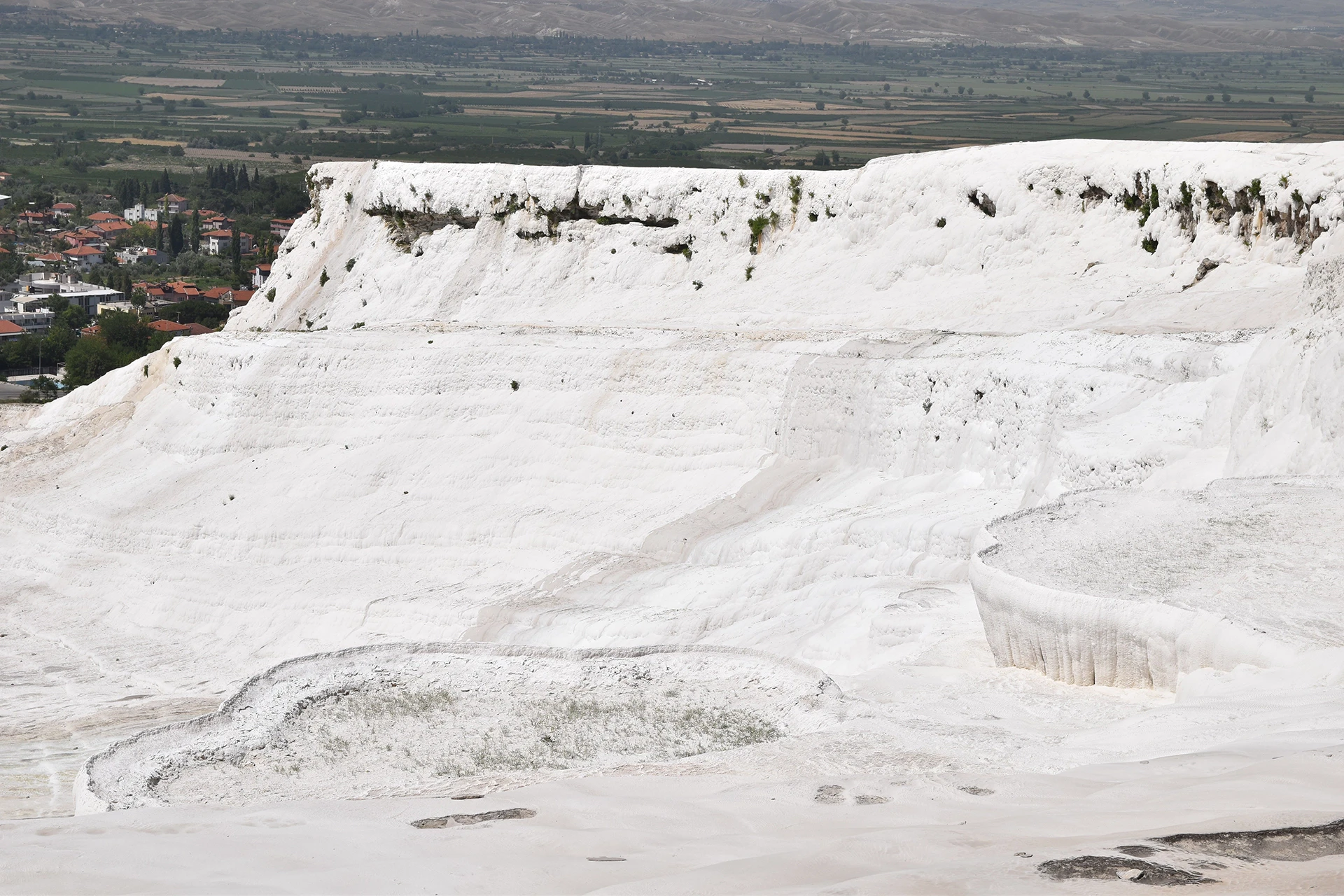 The breathtaking travertine terraces of Pamukkale, Turkey, formed by centuries of mineral deposits from natural hot springs, create a surreal landscape of white cascades.