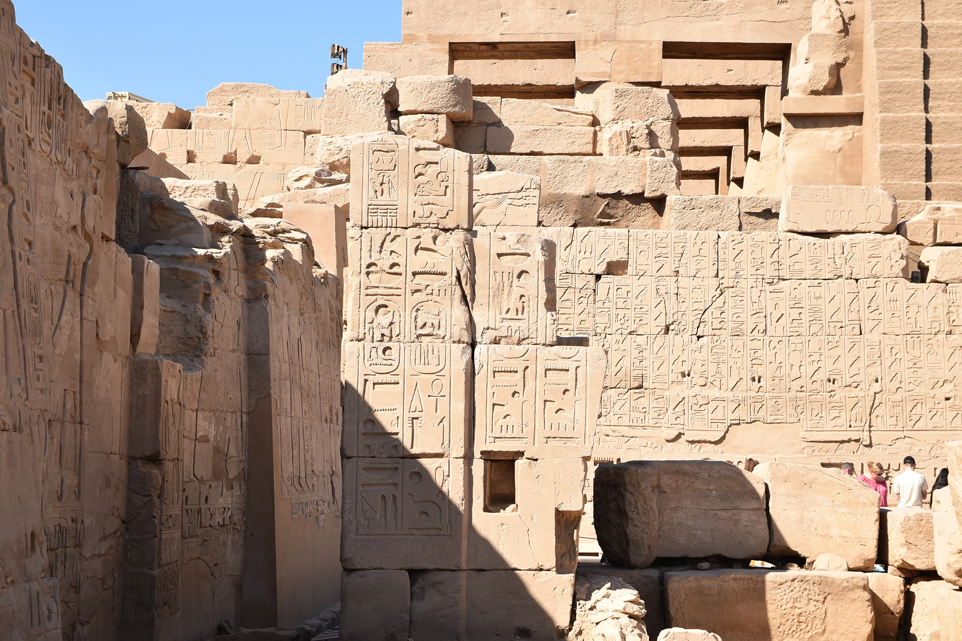 A captivating section of Karnak Temple, featuring walls densely adorned with hieroglyphic inscriptions. These ancient carvings narrate the religious and political achievements of pharaohs, preserving the legacy of Egypt's New Kingdom era.