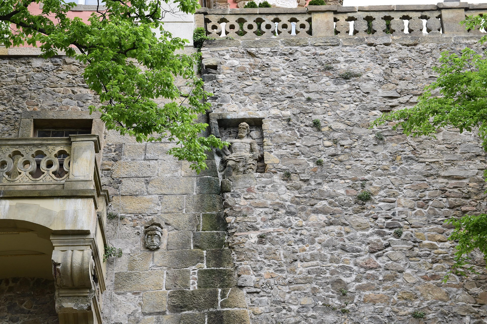 The external elevation of Ksiaz Castle highlights its robust stone architecture, adorned with embedded sculptures and decorative details. These features reflect the castle's rich historical legacy and artistic craftsmanship.