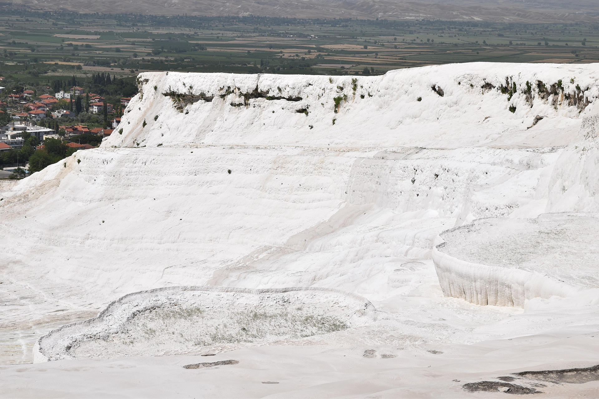 The breathtaking travertine terraces of Pamukkale, Turkey, formed by centuries of mineral deposits from natural hot springs, create a surreal landscape of white cascades.